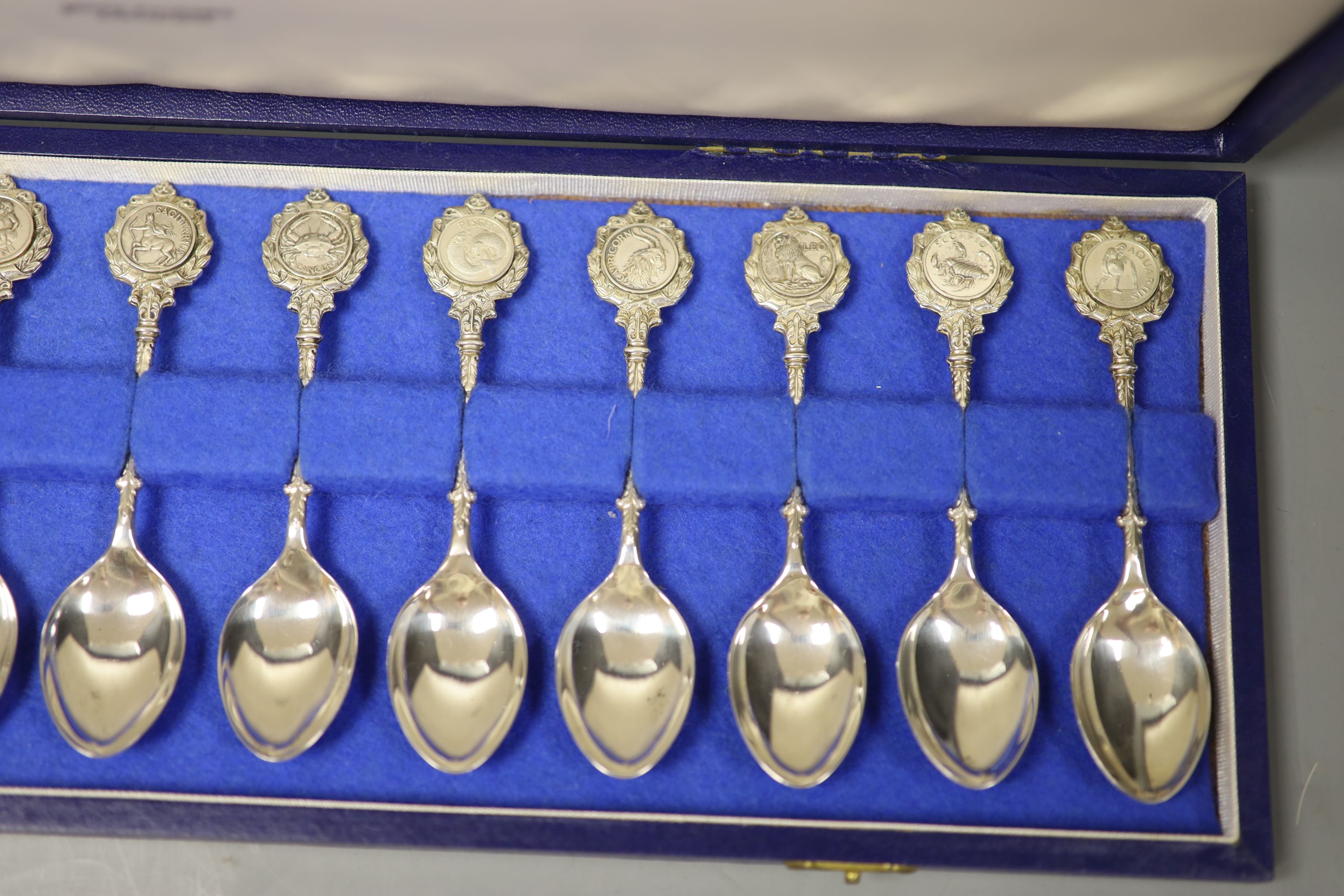 A set of twelve silver Signs of the Zodiac spoons by John Pinches, cased